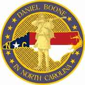 A circular emblem featuring a golden silhouette of Daniel Boone standing in front of a stylized North Carolina state flag and map. The border reads "Daniel Boone in North Carolina" with stars surrounding the edge.